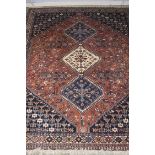 A Yallameh Persian rug, salmon pink ground, three