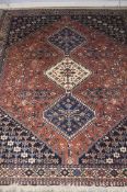 A Yallameh Persian rug, salmon pink ground, three