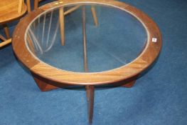 An Astro teak circular and glass inset coffee table
