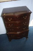 A reproduction mahogany serpentine chest of drawer