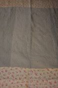 Two Durham quilts, one green with floral trim, the