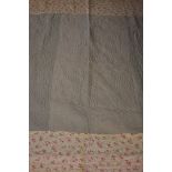 Two Durham quilts, one green with floral trim, the