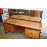 A teak dressing table, 155cm