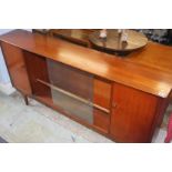 A teak sliding door bookcase