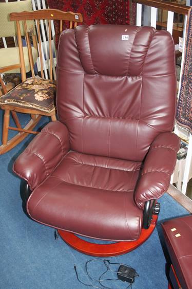 A burgundy leather armchair and footstool