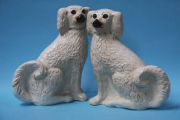 A pair of Victorian Staffordshire Spaniels with gl