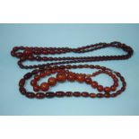 Two strings of amber coloured beads