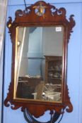 A pair of walnut framed mirrors and one other (3)