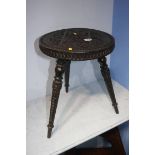 A carved circular stool