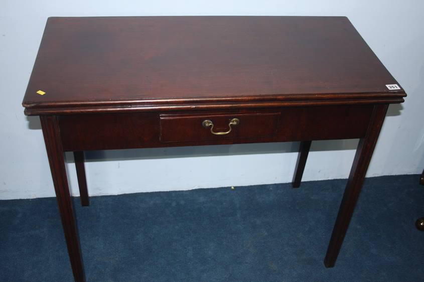 A Georgian mahogany fold over tea table with singl