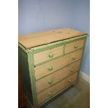 A partially stripped pine straight front chest of five drawers