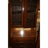 A walnut chest of drawers and a mahogany bureau bookcase (2)