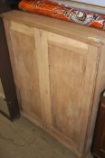 A stripped mahogany cabinet
