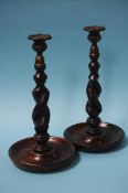 A pair of oak barley twist candlesticks