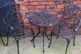 A garden table and pair of matching carver style c
