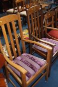 A pair of oak carver chairs, each painted with mas