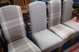 A set of four upholstered dining chairs