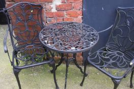 A garden table and pair of matching carver style chairs