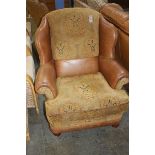 Pair of tan leather armchairs and footstool