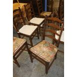 Eight Ercol ladderback chairs