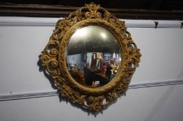 Circular gilt framed mirror