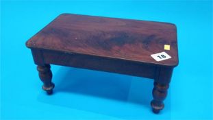 A miniature Victorian mahogany dining table. 31cm long 19cm wide
