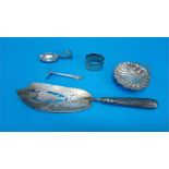 A Georgian silver fish slice, London 1802, a silver shell dish, a napkin ring, a silver caddy