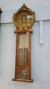 A Victorian carved oak Royal Polytechnic barometer by Joseph Davis and Company, London. 105cm long