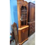 A reproduction walnut corner cabinet.