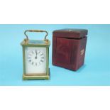 A small brass carriage clock and leather case. 10.5cm high