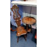 A carved oak stool and a carved occasional table.