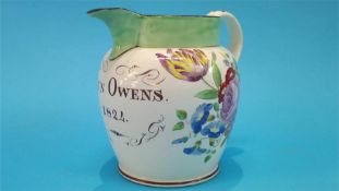 A 19th Century Sunderland jug, to Ann Owens, dated 1824, decorated with flowers. 15cm high