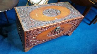 A carved Oriental camphorwood chest.