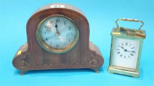 A small carriage clock and an Edwardian mantel clock.