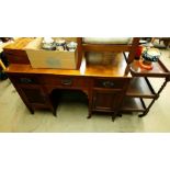 A mahogany desk, elbow chair and a tea trolley.