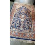 A blue ground floral rug. 214cm x 128cm