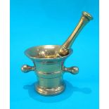 A brass pestle and mortar.