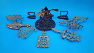 Seven various brass trivets, two irons etc.