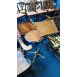 An oak circular occasional table, with swivel reading stand and metal base.