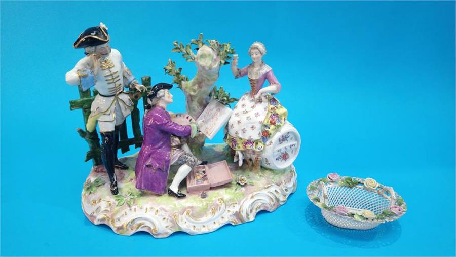 An early 20th Century German (Dresden) porcelain group of two Gentlemen and a Lady seated on a