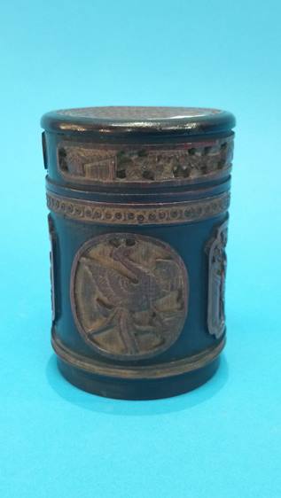 A carved bamboo canister, decorated with panels of figures and dragons. 14 cm high