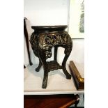 An Oriental hardwood plant pedestal, with inset marble top. 30cm diameter 40cm high