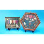 Two cased sets of un-named military medals.