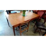 A teak extending dining table and four chairs.