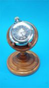 A white metal half Hunter pocket watch and a treen watch stand.