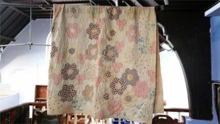 A patchwork quilt, with patterned reverse.