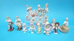 A collection of twenty one Continental porcelain figure heads and a small pair of Continental