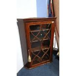 A mahogany glazed corner cabinet.