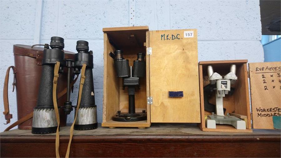 A pair of Barr and Stroud 7 X CF25 binoculars, with case and two microscopes.