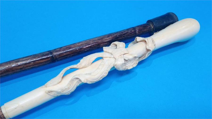 An ivory mounted walking cane carved with ribbons and ivory tip and another cane. (2) 85cm long - Image 2 of 3